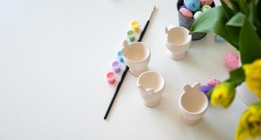 Top view eater banner with paint,eggs,brush and egg cups with place for text photo