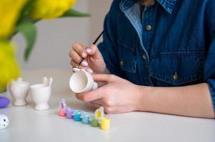 Pastel color Easter egg holder. Woman preparing for spring holiday photo