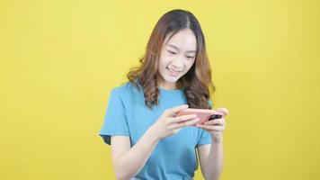 Asian women play online games on their smartphones. video