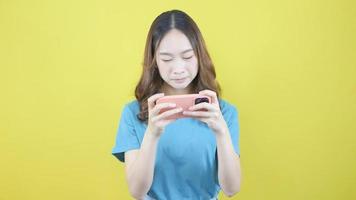 Asian woman playing car fun game online on smartphone video