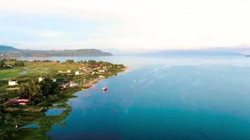 mooi antenne visie van meer toba Bij zonsopkomst met keer bekeken van balige stad en woon- gebieden in de omgeving van meer toba video