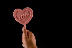 Heart candy on dark background photo