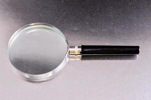 Magnifying glass on metal photo