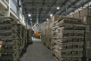 Storage warehouse with packaged goods on wooden pallet at recycle paper factory. Preparation shipment of products. Logistics, transportation and distribution facility for delivery. Supply chain cargo photo