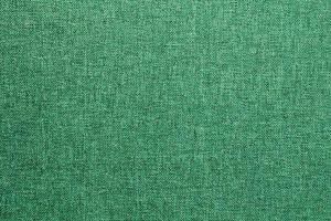 Abstract design background of green emerald coarse-grained intersection texture of rough fabric with an interlacing. Linen sack textile canvas burlap cloth. Close-up, mock up, top view photo