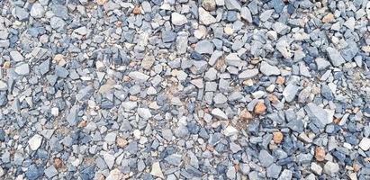 Pattern of small gravel, rock or stone on the ground for background. Hard material, Art wallpaper and Group of object concept photo