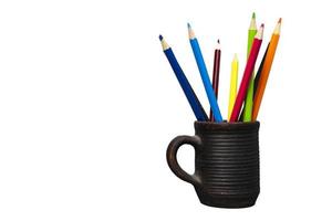 Colored funny pencils in a clay cup Isolated on a white background, Colored pencils in a clay cup. photo