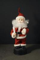 Santa Claus doll in a red suit with a candle photo