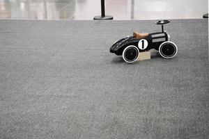 children's racing car with a steering wheel for riding small children photo