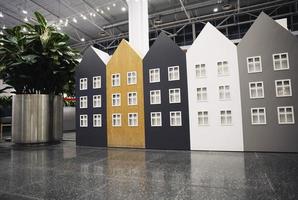 models of colored houses lined up in a row, housing concept, mortgage photo