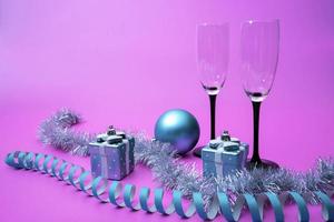 Champagne glasses, New Year's gifts and tinsel and Christmas decorations photo