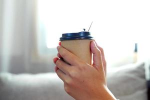 Asian woman enjoying coffee at home, the concept of resting after work, relaxing, cozy corner, peaceful corner. Soft and selective focus. photo