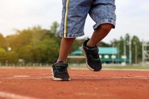 running forward on the treadmill of an Asian boy. the concept of outdoor play, outdoor activities, leisure activities, exercise. Soft and selective focus. photo