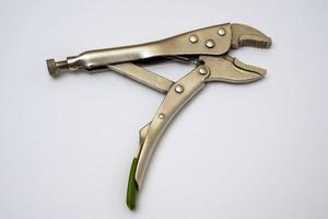 open locking pliers on a white background. Artisan's hand tool close-up photo