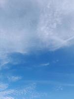 Beautiful white clouds on deep blue sky background. Large bright soft fluffy clouds are cover the entire blue sky. photo