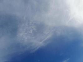 Beautiful white clouds on deep blue sky background. Large bright soft fluffy clouds are cover the entire blue sky. photo