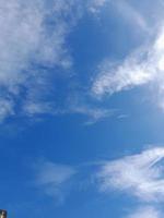 Beautiful white clouds on deep blue sky background. Large bright soft fluffy clouds are cover the entire blue sky. photo