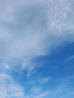 Beautiful white clouds on deep blue sky background. Large bright soft fluffy clouds are cover the entire blue sky. photo