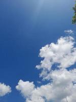 Beautiful white clouds on deep blue sky background. Large bright soft fluffy clouds are cover the entire blue sky. photo