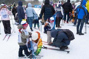 Annual All-Russian sports event action Ski Track of Russia. Sporty lifestyle for adults, children, family holiday on cross-country skiing - mass race on a snowy track. Russia, Kaluga - March 4, 2023 photo