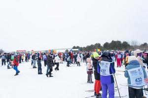 Annual All-Russian sports event action Ski Track of Russia. Sporty lifestyle for adults, children, family holiday on cross-country skiing - mass race on a snowy track. Russia, Kaluga - March 4, 2023 photo