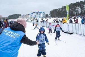 Annual All-Russian sports event action Ski Track of Russia. Sporty lifestyle for adults, children, family holiday on cross-country skiing - mass race on a snowy track. Russia, Kaluga - March 4, 2023 photo