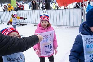 Annual All-Russian sports event action Ski Track of Russia. Sporty lifestyle for adults, children, family holiday on cross-country skiing - mass race on a snowy track. Russia, Kaluga - March 4, 2023 photo