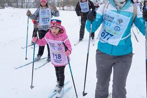 Annual All-Russian sports event action Ski Track of Russia. Sporty lifestyle for adults, children, family holiday on cross-country skiing - mass race on a snowy track. Russia, Kaluga - March 4, 2023 photo