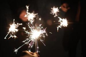 Friends holding fairy stick fireworks photo