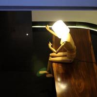 Illuminated humanoid table lamp artwork photo