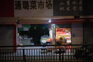 Wet market behind the fence at night photo