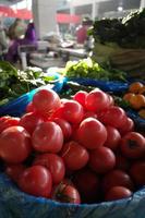 Tomatoes in the sun inside the wet market photo