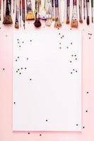 Drawing album frame, row brush and golden stars on pink background