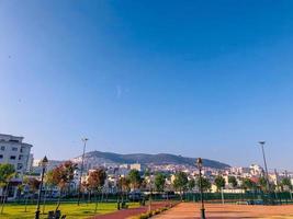 Discover the vibrant and bustling beauty of an urban public park, capturing the unique charm and energy of city life in a scenic display of nature and architecture photo