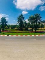 Roundabout road adorned with roses and palms photo