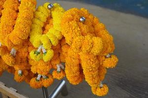 Marigolds, lotus flowers are brought to pay homage to the Lord Buddha. photo