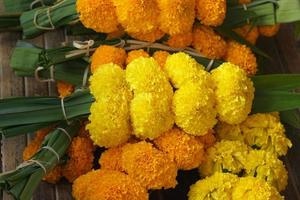 Marigolds, lotus flowers are brought to pay homage to the Lord Buddha. photo