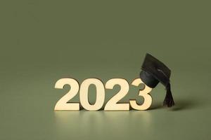 Class of 2023 concept. Wooden number 2023 with graduated cap on colored background photo