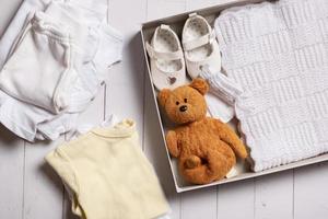 Childrens clothes, shoes and toys in box. Second hand, clothing recycling concept photo