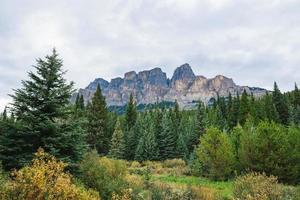 Crowfoot mountain in Alberta, Canada on a cloudy day with stunning mountains and green trees photo