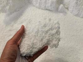 Urea chemical fertilizer, white foam granules, agglomerate In the hands of farmers photo