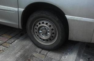 Modern steel and rubber car van transportation vehicle tire wheel isolated photo on landscape background.