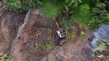 Bird eye view excavator bulldoze the oil palm tree video