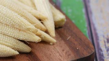 Close up of baby corn in a chopping board on table video