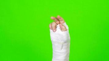 Hand showing the sign of victory and splint isolated on green screen background video