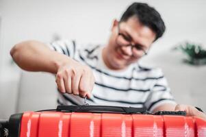 Close-up of man have finished packing and is locking them photo