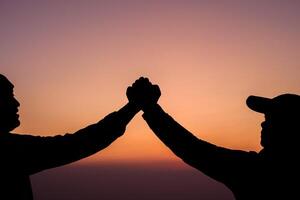 Silhouette of Teamwork helping hand trust help photo