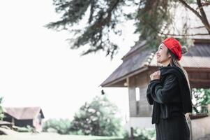 Portrait of Asian young woman in winter costume praying in the morning at the woodland photo