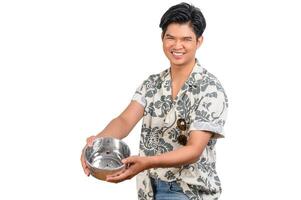 Portrait young man with water bowl in Songkran Festival photo