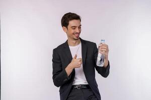 Portrait of Happy young man showing water in a bottle isolated over white background photo